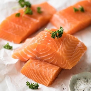 Raw salmon fillets with herbs